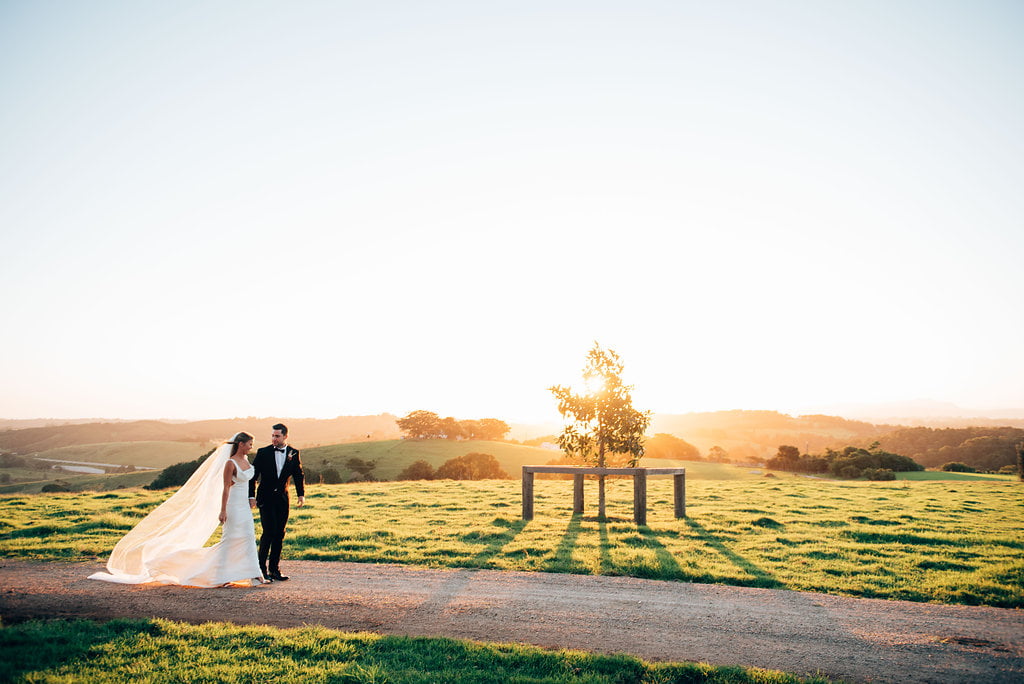 A married couple walking in the twilight at a Byron Bay wedding venue